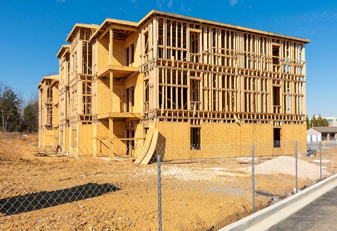 a close-up of temporary chain link fences enclosing a construction site, signaling progress in the project's development in Chester, SD